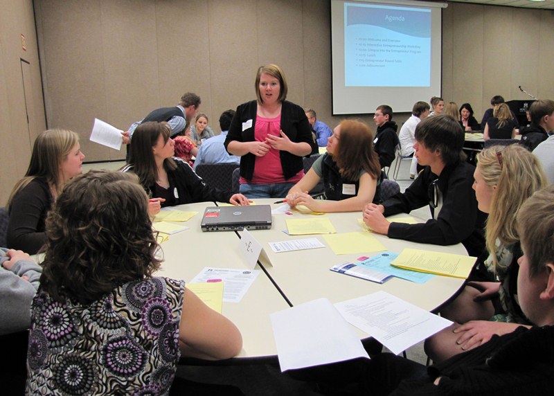 Entrepreneur Day participants sit around a table.