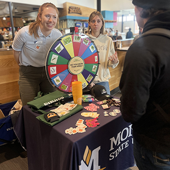 two girls hosting a tabling event in the dining hall