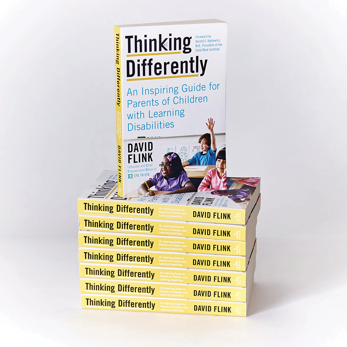 A stack of books with yellow spines, that are titled Thinking Differently