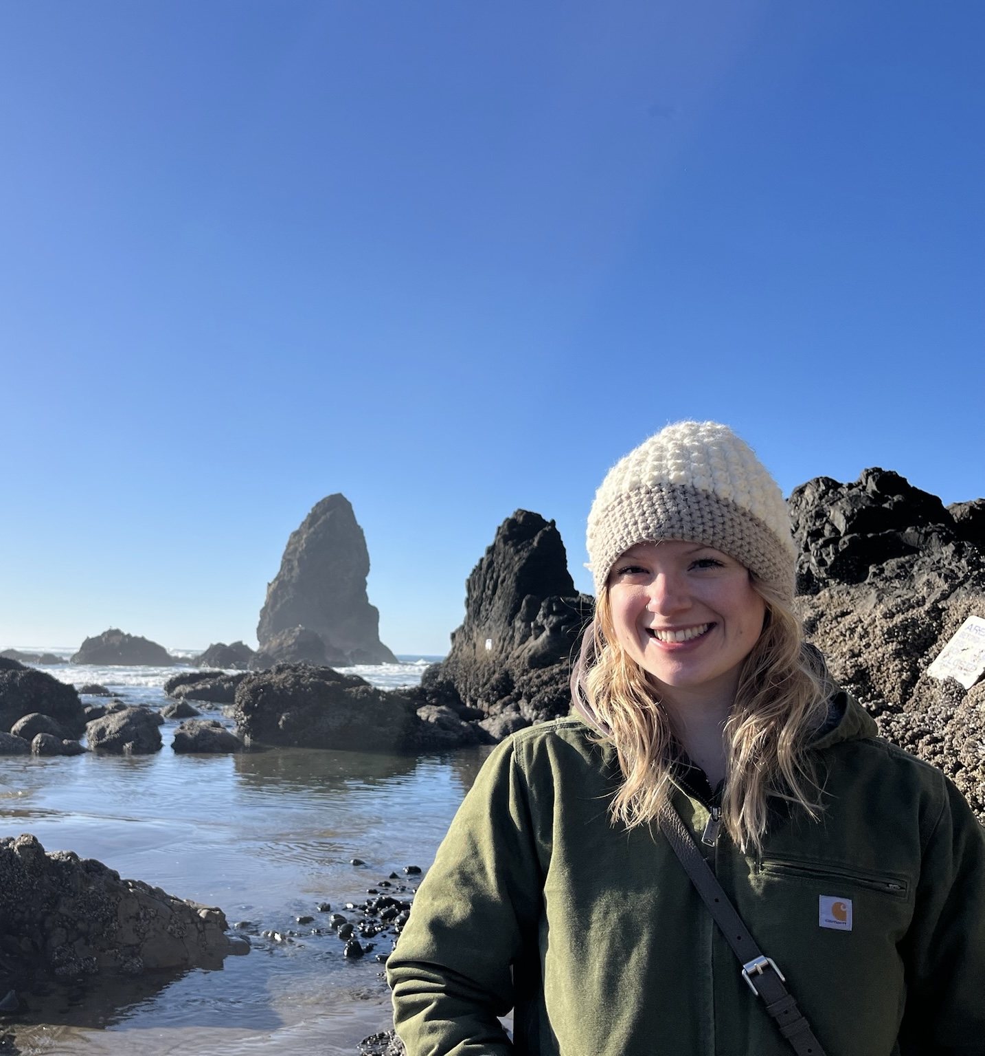 Maddie Wilson on rocky shoreline