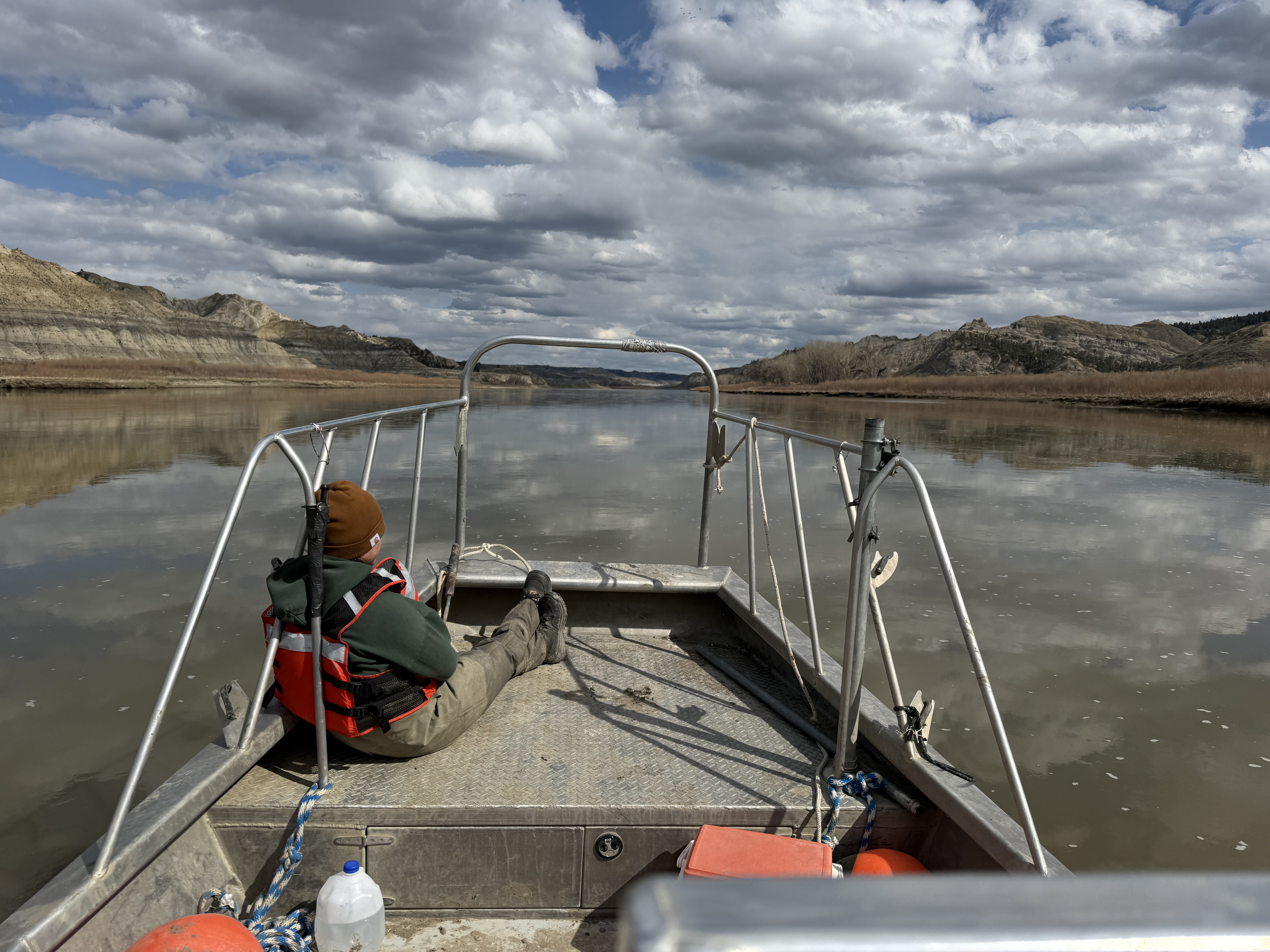Student sitting on a boat going down river