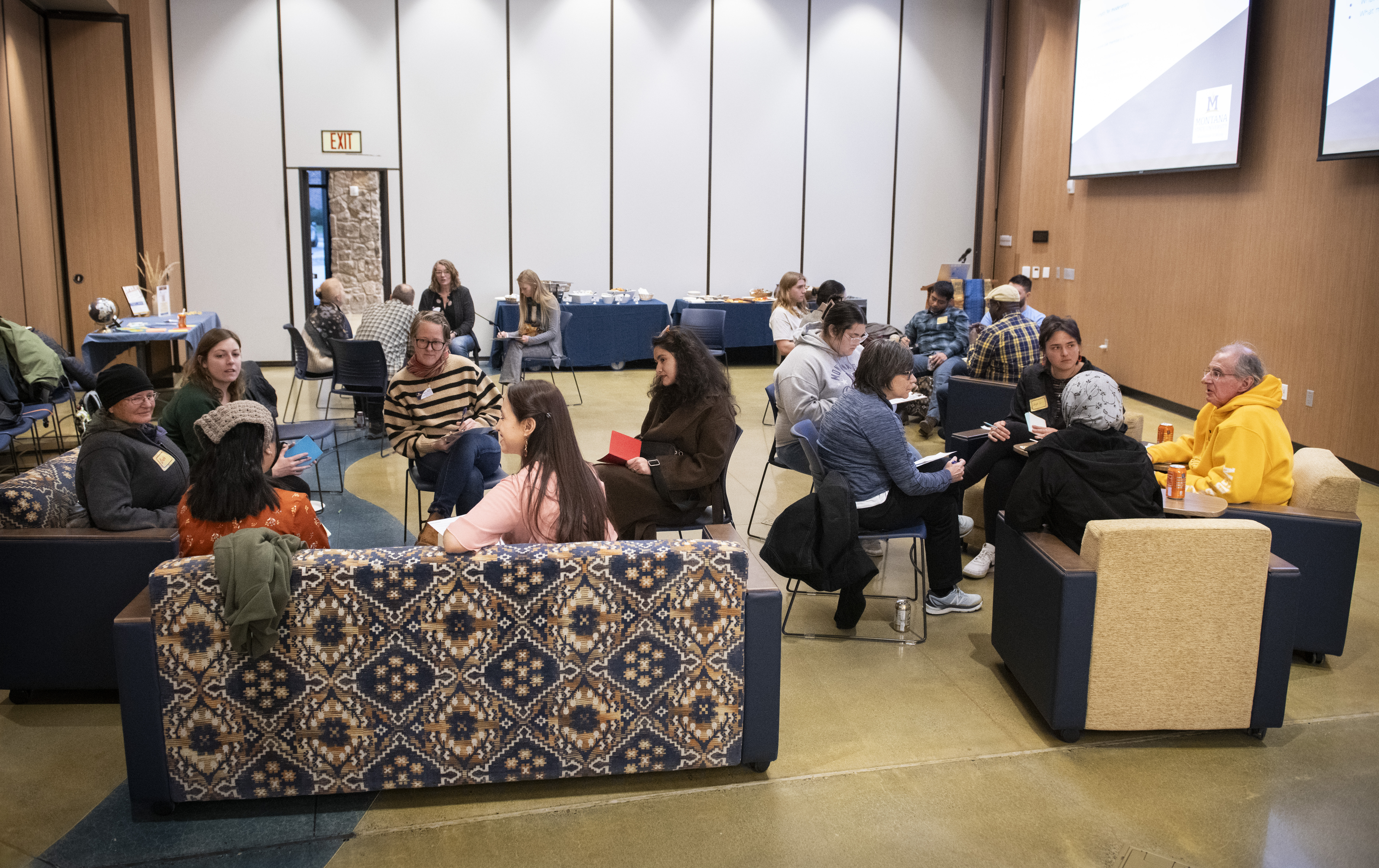 Small groups engaged in converstaion in American Indian Hall for the Fall 2023 Languge and Story exchange