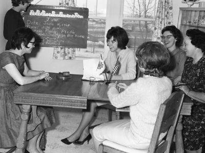 4-H club members sitting around a table