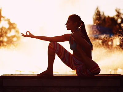 woman practicing yoga in the park