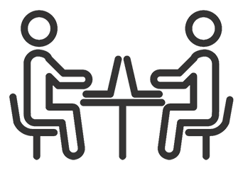 Two people at a table with laptops