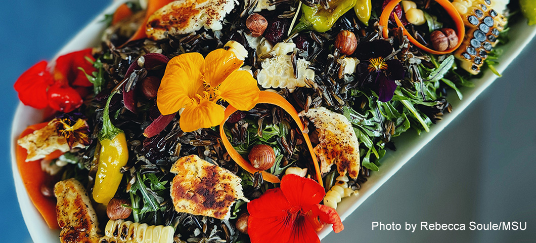 wild rice summer salad with nasturtium flowers in a bowl