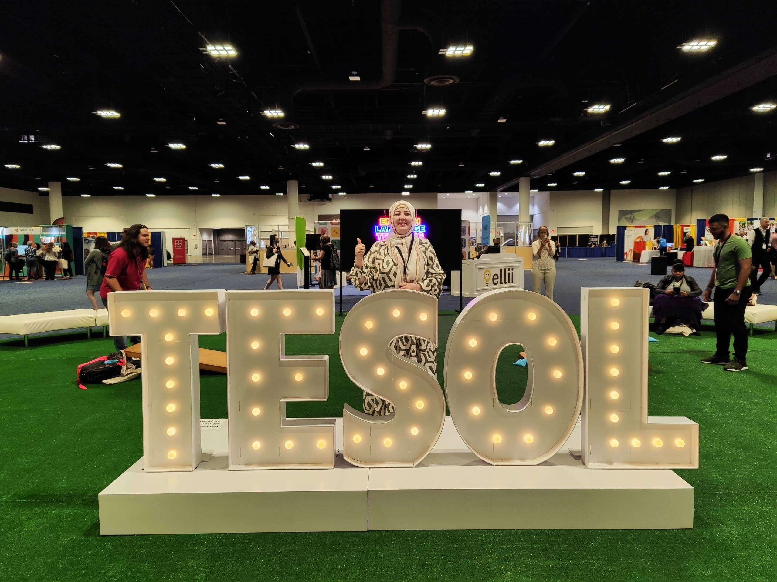 Gulrukh at in front of TESOL sign at conference