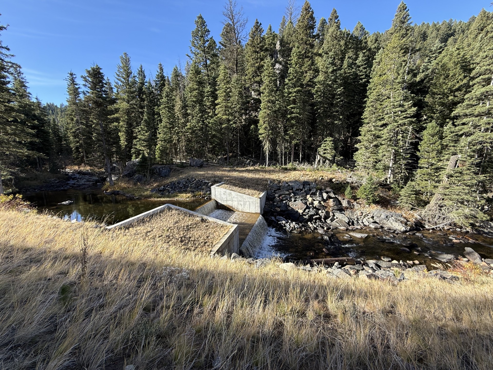 A river with a dam in the middle of it