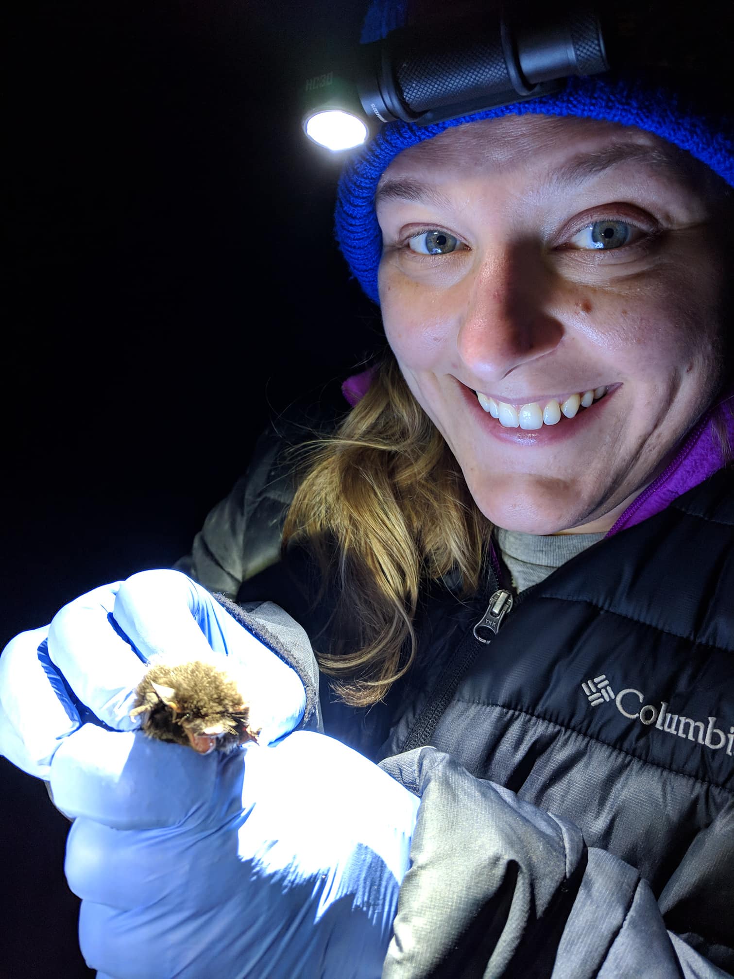 Catherine Haase in the field holding a bat