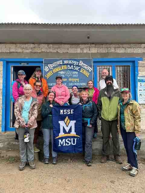 Posing with the MSU flag in front of the Shree Himalaya Basic School.