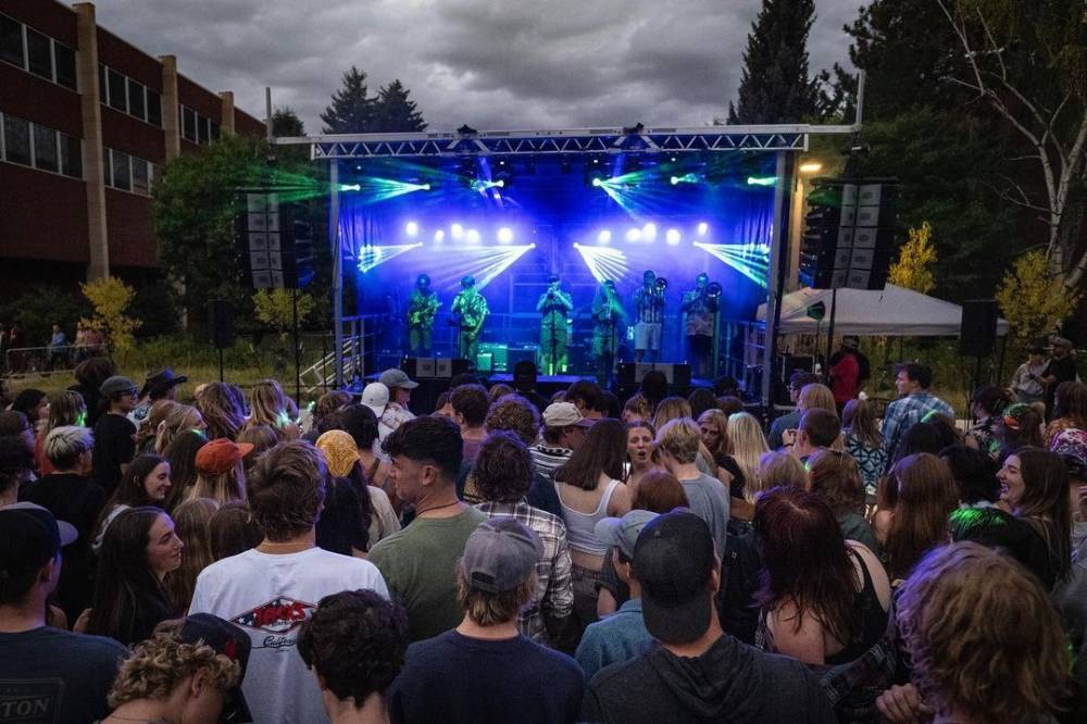 people standing in a crowd by a stage