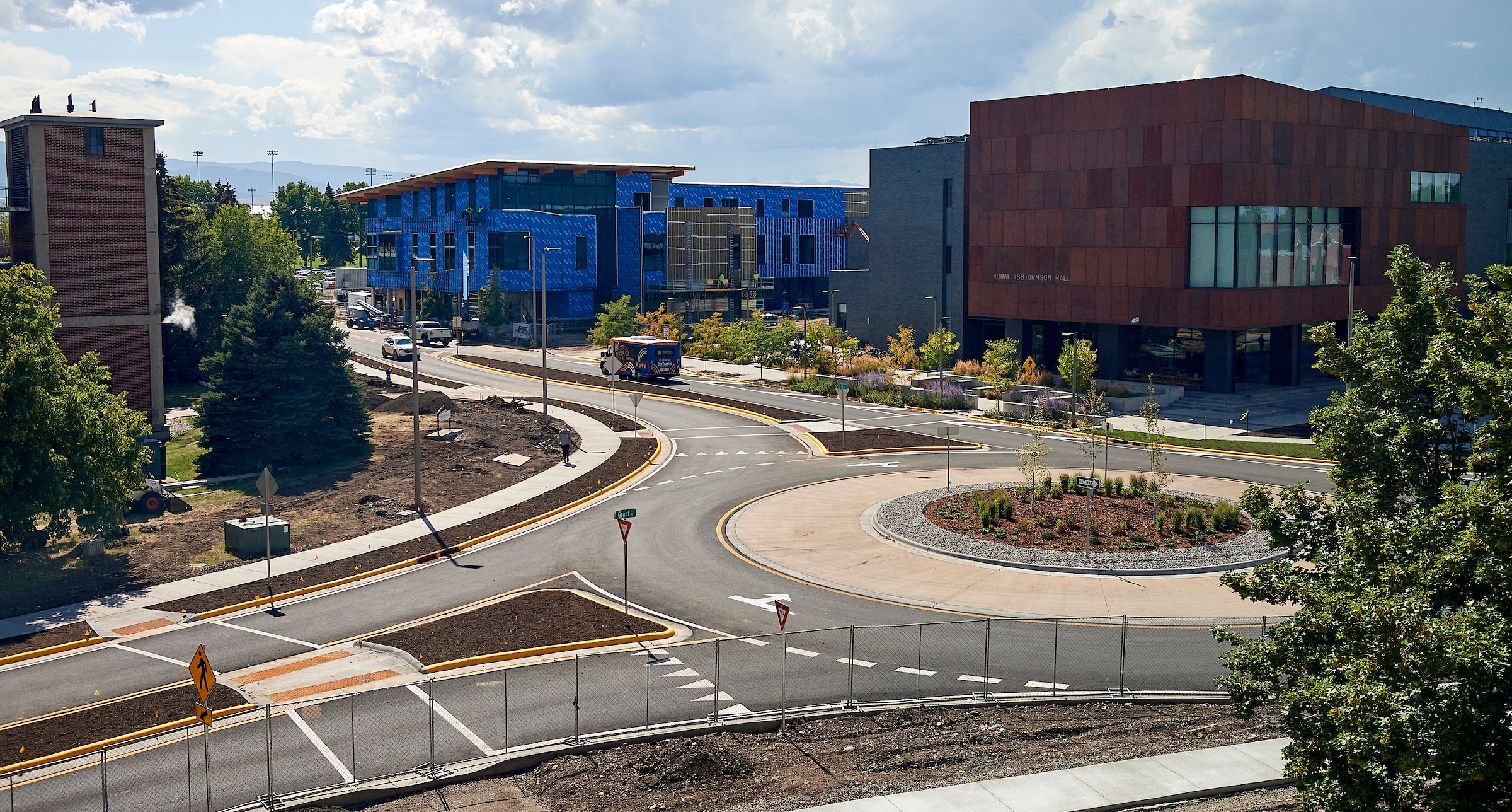 A roundabout with a building under construction in the background