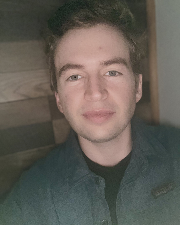 A person wearing a dark green button up jacket