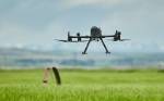 Geospatial Skills Camp drone Small drone hovers over a pasture as part of a geospatial skills camp