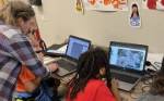 Geospatial Skills Camp Mentor assists students working at computer stations.